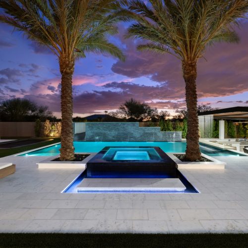 Modern pool with water wall, slide and covered pavilion on 196th Place in Queen Creek, AZ by Envy Pools