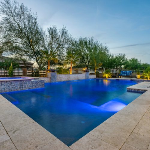 Geometric pool with raised spa and covered outdoor kitchen on 195th Way in Queen Creek, AZ by Envy Pools
