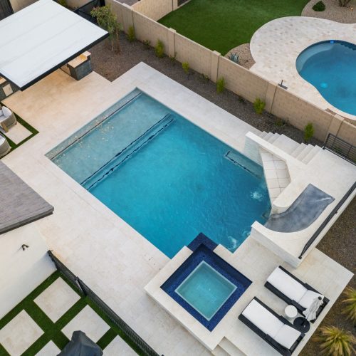 Overhead view of a rectangular pool with tanning ledge, raised spa and water slide