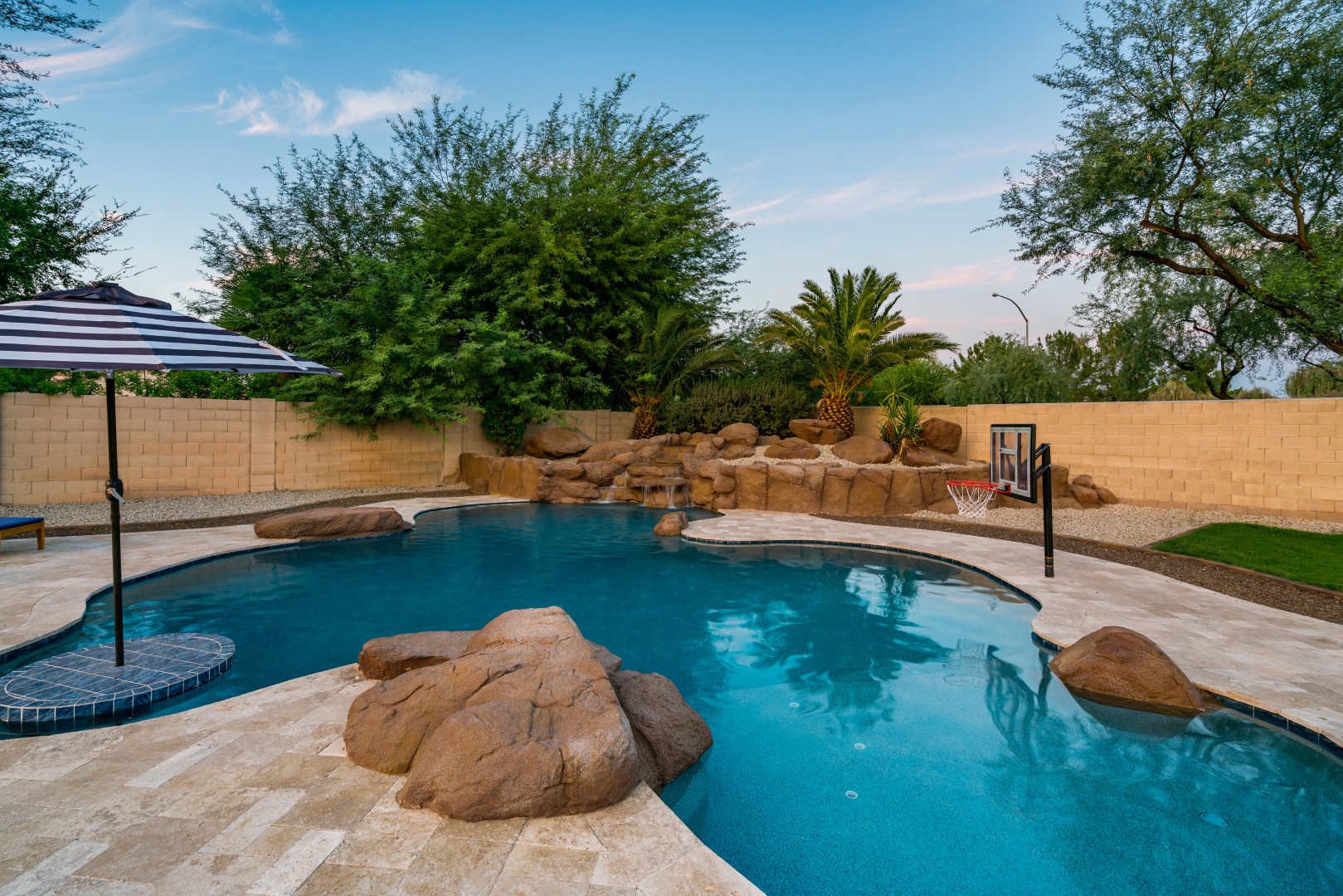 Custom freeform pool and boulder waterfall on Lobo Avenue in Mesa, AZ by Envy Pools