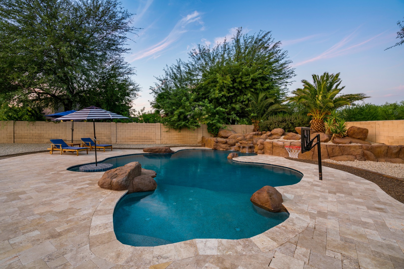 Custom freeform pool and boulder waterfall on Lobo Avenue in Mesa, AZ by Envy Pools