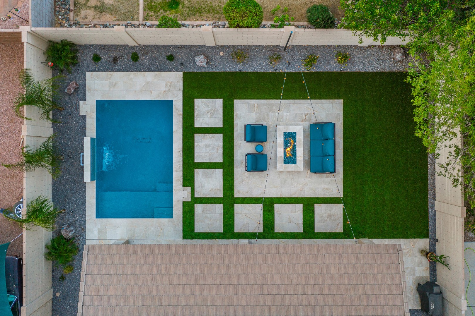 Custom rectangular pool with fish-scale tile water feature and fire pit in Gilbert, AZ by Envy Pools