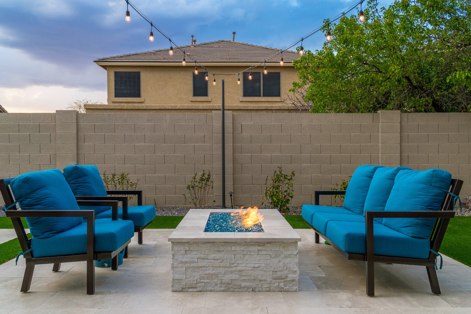 Custom rectangular pool with fish-scale tile water feature and fire pit in Gilbert, AZ by Envy Pools