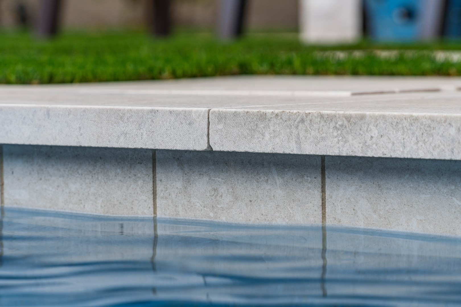 Custom rectangular pool with fish-scale tile water feature and fire pit in Gilbert, AZ by Envy Pools