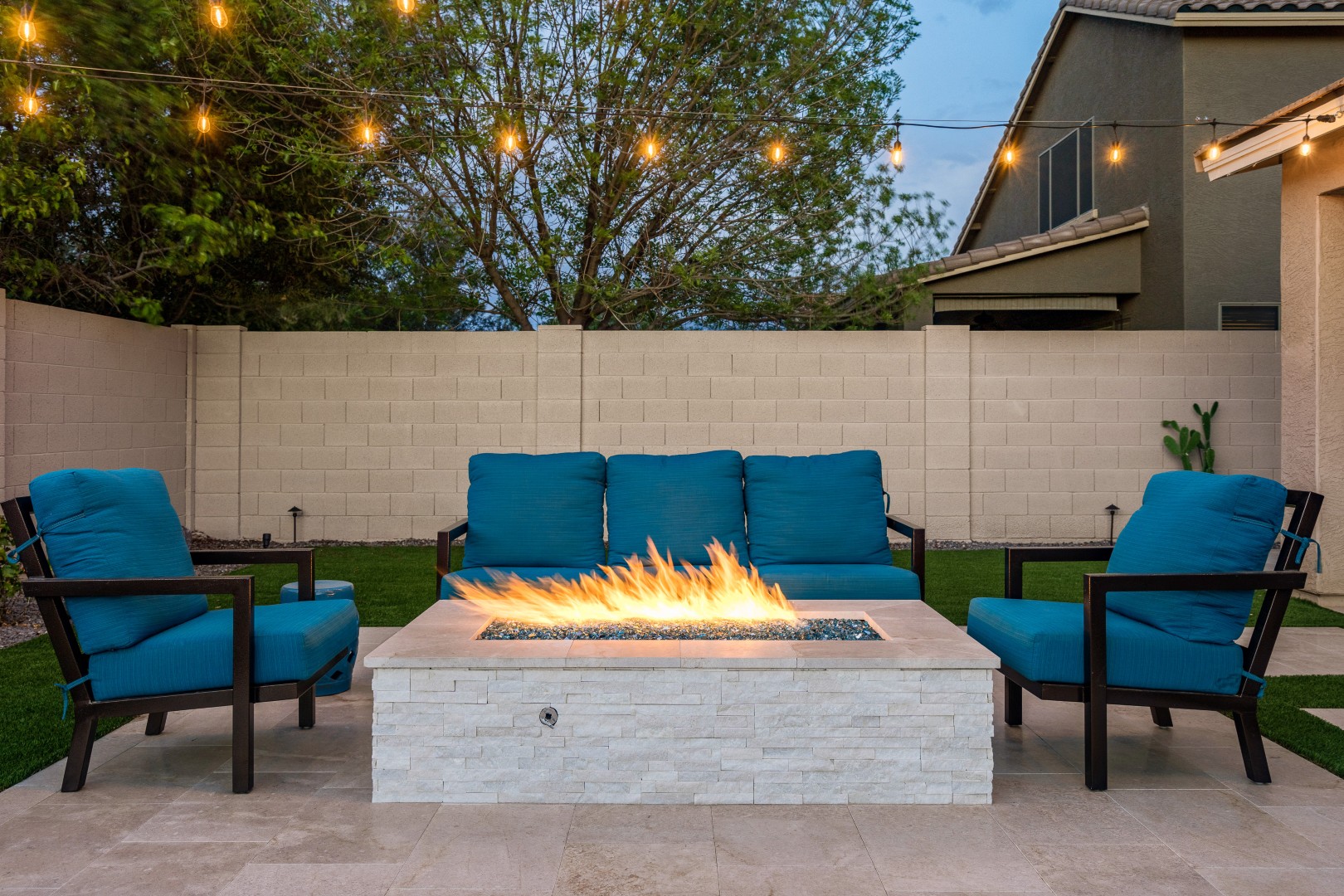 Custom rectangular pool with fish-scale tile water feature and fire pit in Gilbert, AZ by Envy Pools