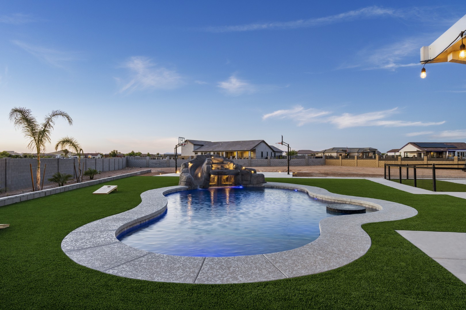 Custom pool with rock waterslide on Paoli Street in Queen Creek, AZ by Envy Pools