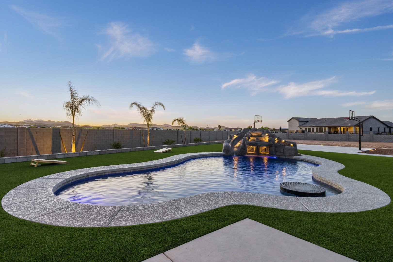 Custom pool with rock waterslide on Paoli Street in Queen Creek, AZ by Envy Pools