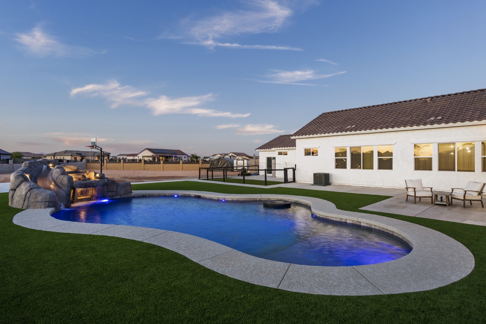 Custom pool with rock waterslide on Paoli Street in Queen Creek, AZ by Envy Pools