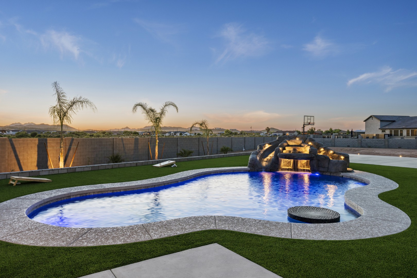 Custom pool with rock waterslide on Paoli Street in Queen Creek, AZ by Envy Pools