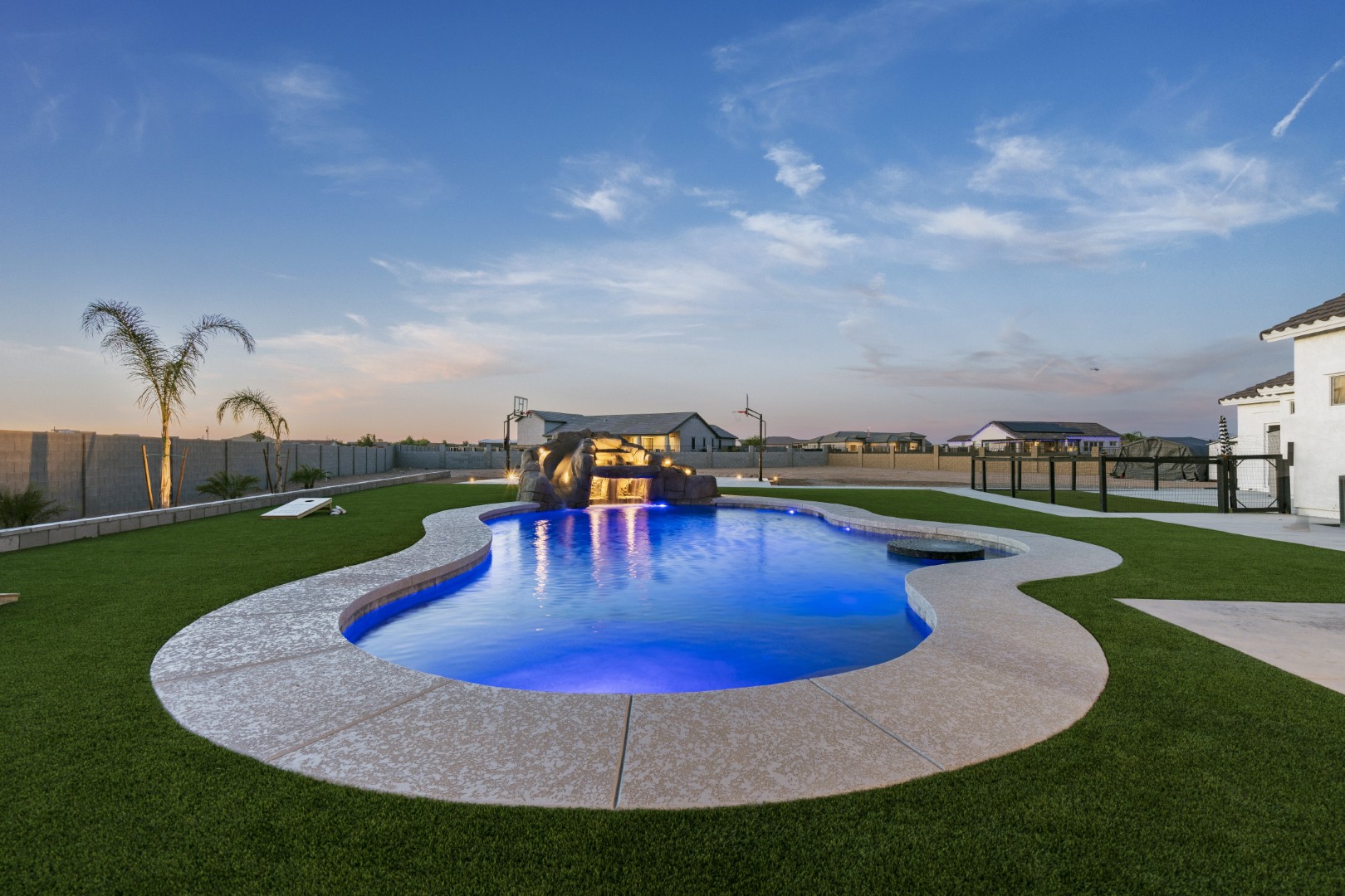 Custom pool with rock waterslide on Paoli Street in Queen Creek, AZ by Envy Pools
