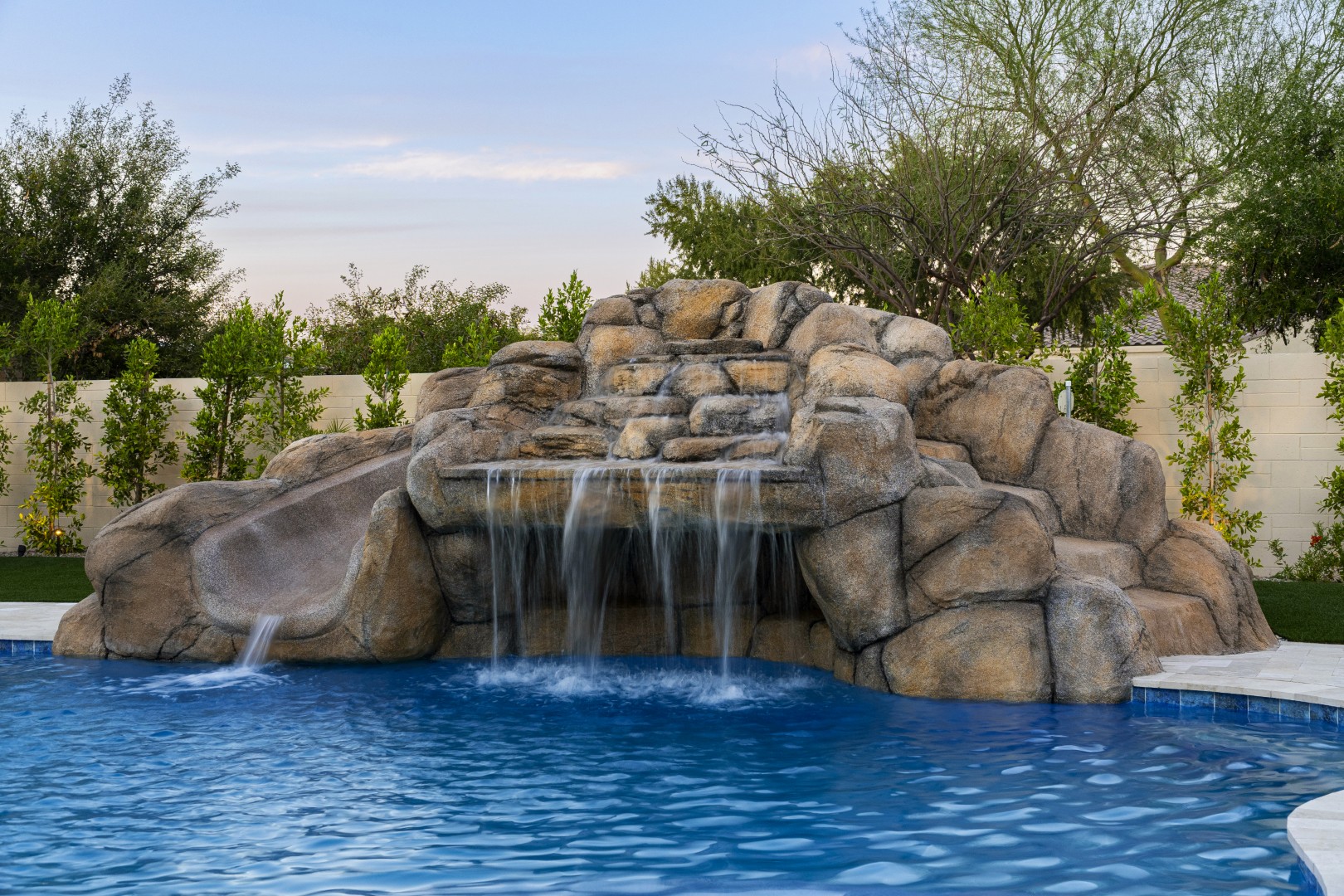 Custom pool with rock waterfall on Quantum Way in Mesa, AZ by Envy Pools