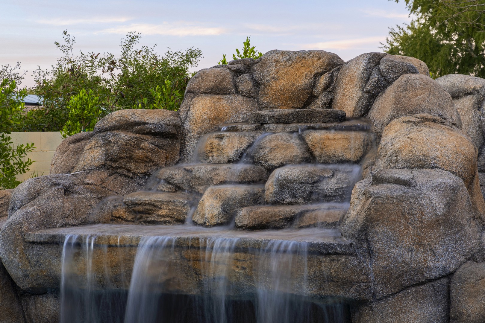 Custom pool with rock waterfall on Quantum Way in Mesa, AZ by Envy Pools
