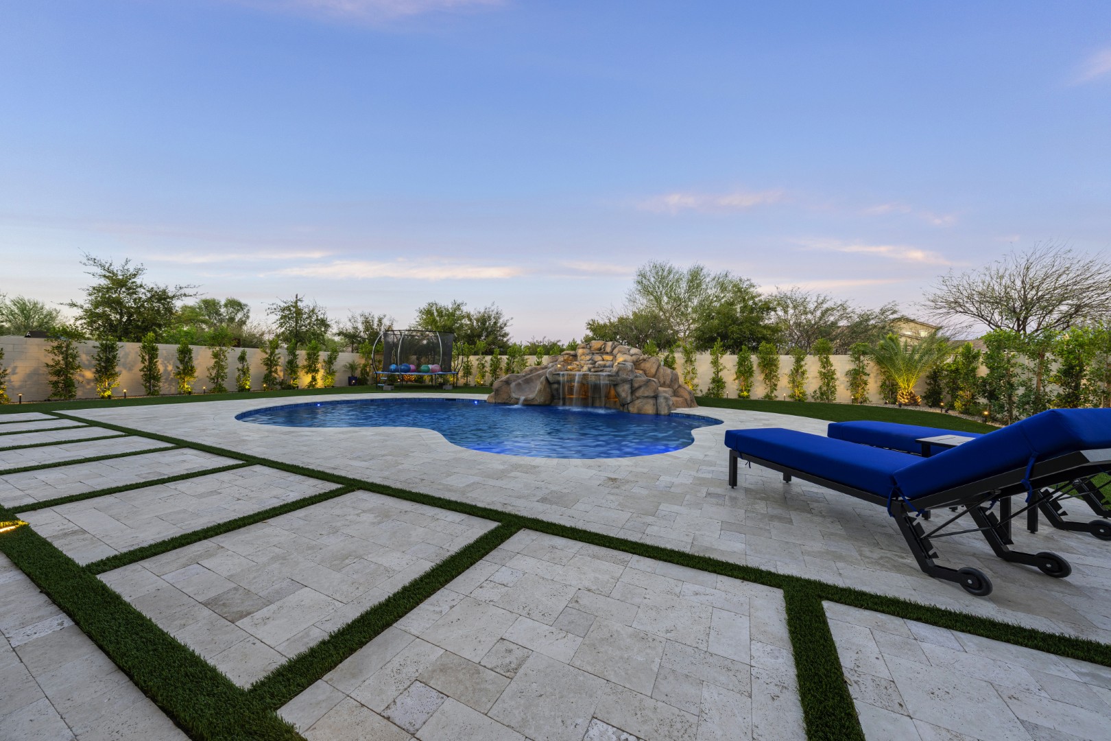 Custom pool with rock waterfall on Quantum Way in Mesa, AZ by Envy Pools