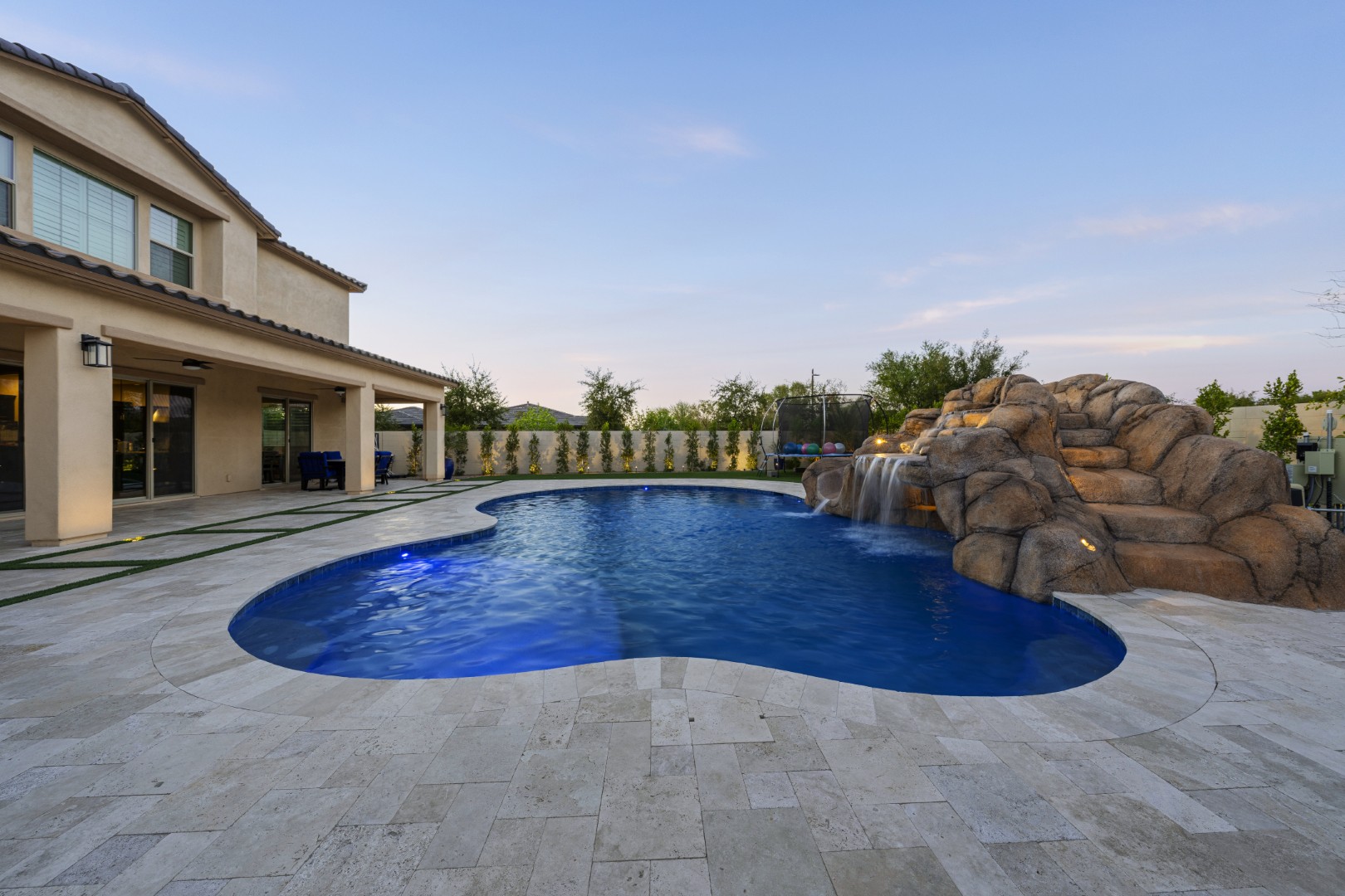 Custom pool with rock waterfall on Quantum Way in Mesa, AZ by Envy Pools