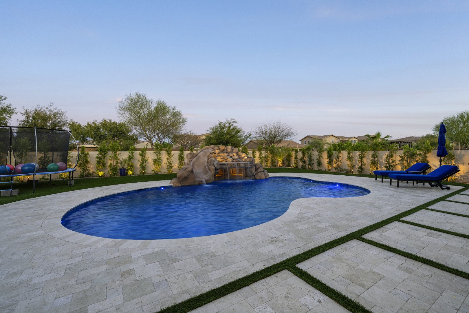 Custom pool with rock waterfall on Quantum Way in Mesa, AZ by Envy Pools