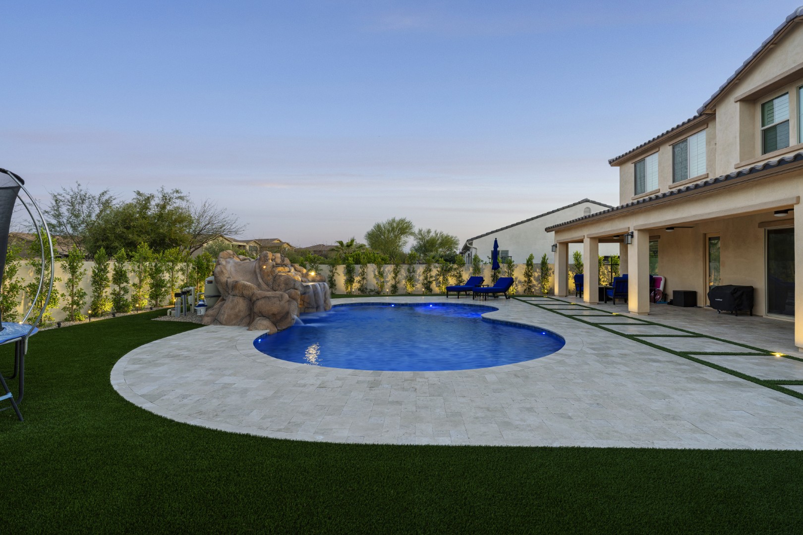 Custom pool with rock waterfall on Quantum Way in Mesa, AZ by Envy Pools