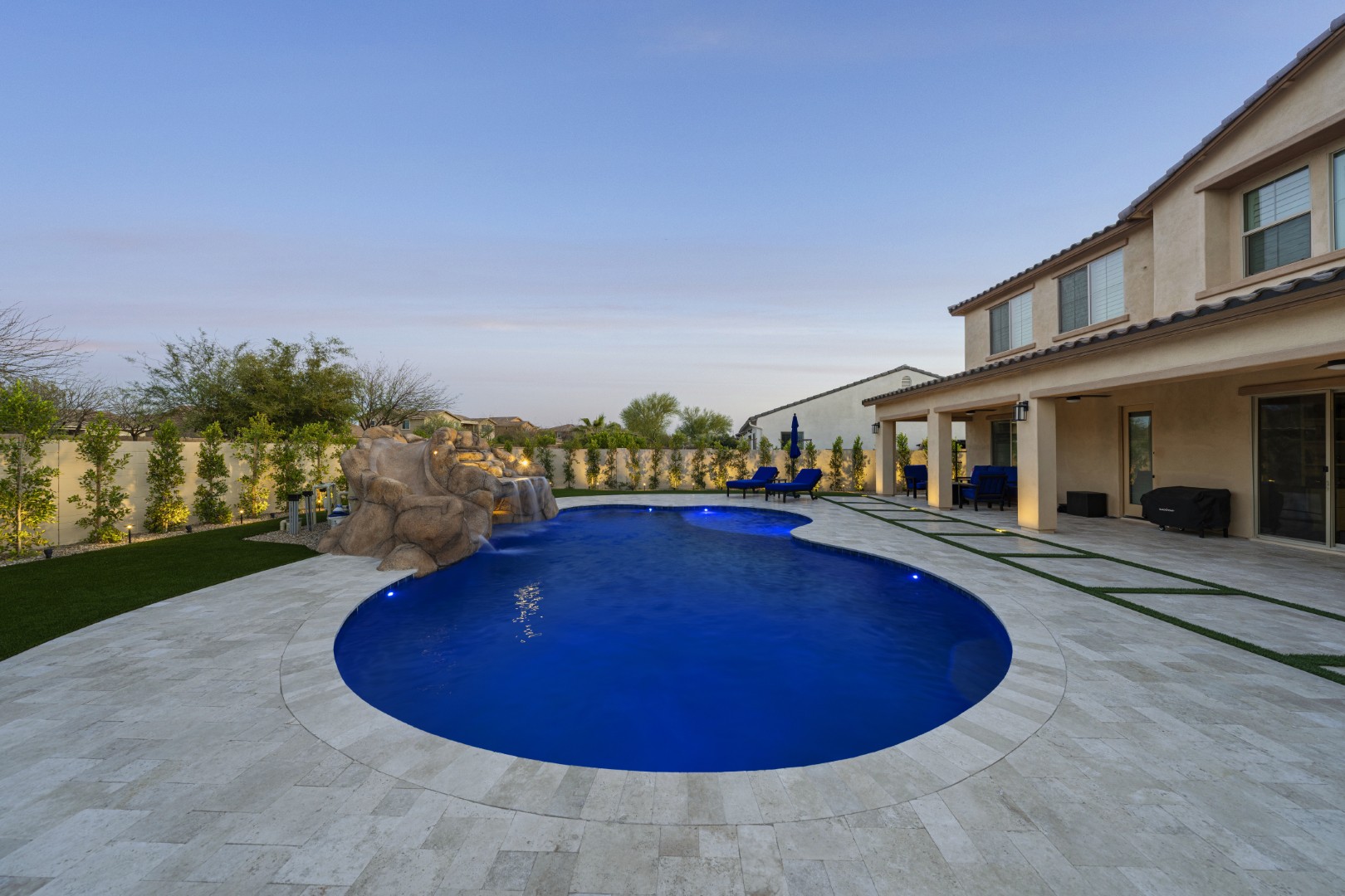 Custom pool with rock waterfall on Quantum Way in Mesa, AZ by Envy Pools