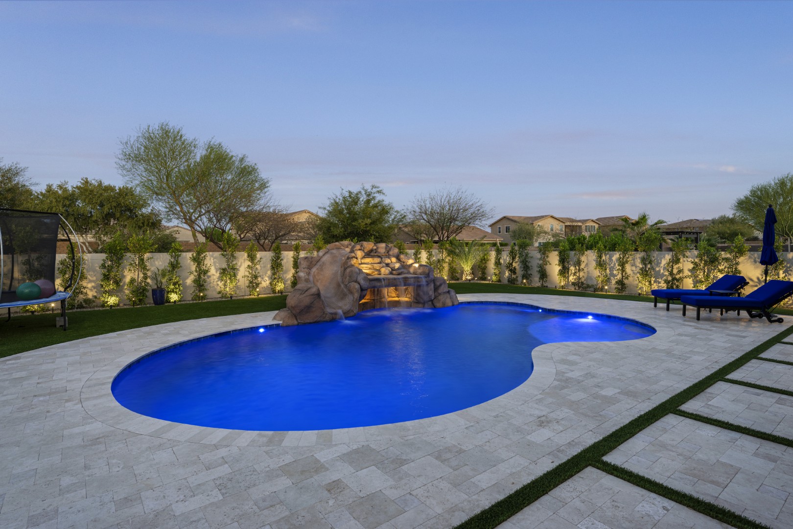 Custom pool with rock waterfall on Quantum Way in Mesa, AZ by Envy Pools