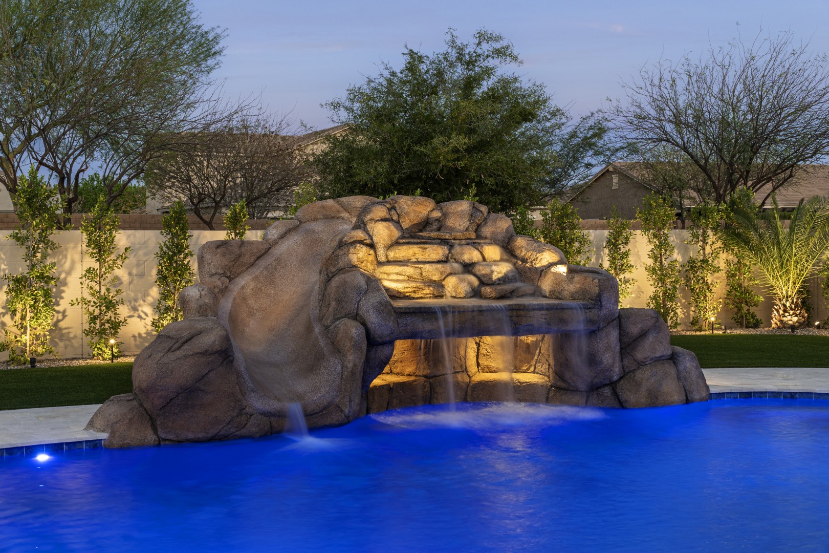 Custom pool with rock waterfall on Quantum Way in Mesa, AZ by Envy Pools