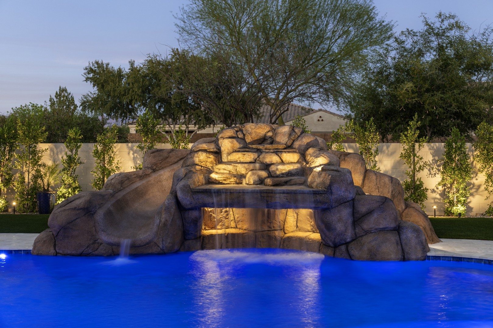 Custom pool with rock waterfall on Quantum Way in Mesa, AZ by Envy Pools