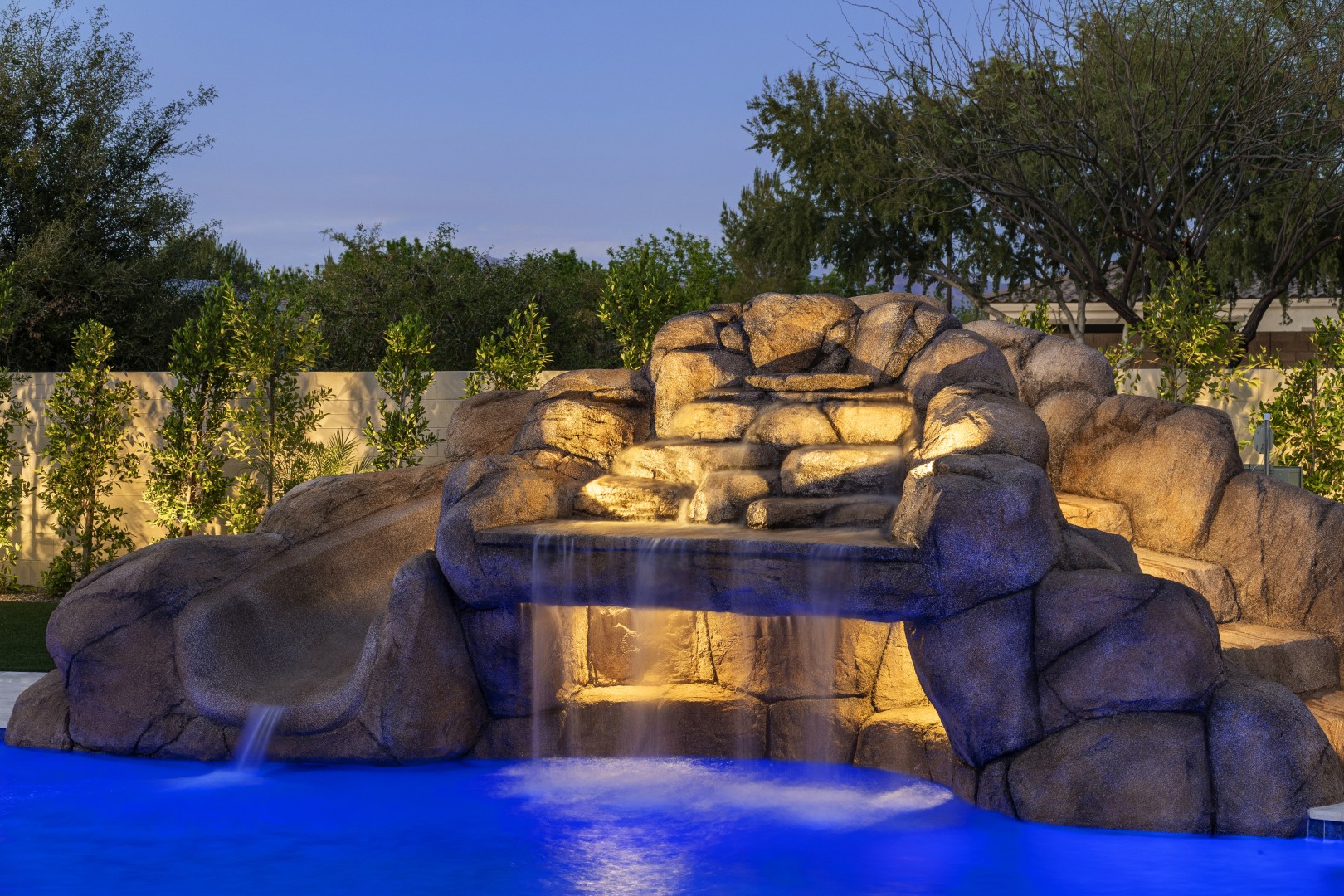 Custom pool with rock waterfall on Quantum Way in Mesa, AZ by Envy Pools