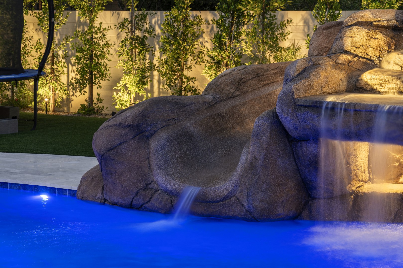Custom pool with rock waterfall on Quantum Way in Mesa, AZ by Envy Pools