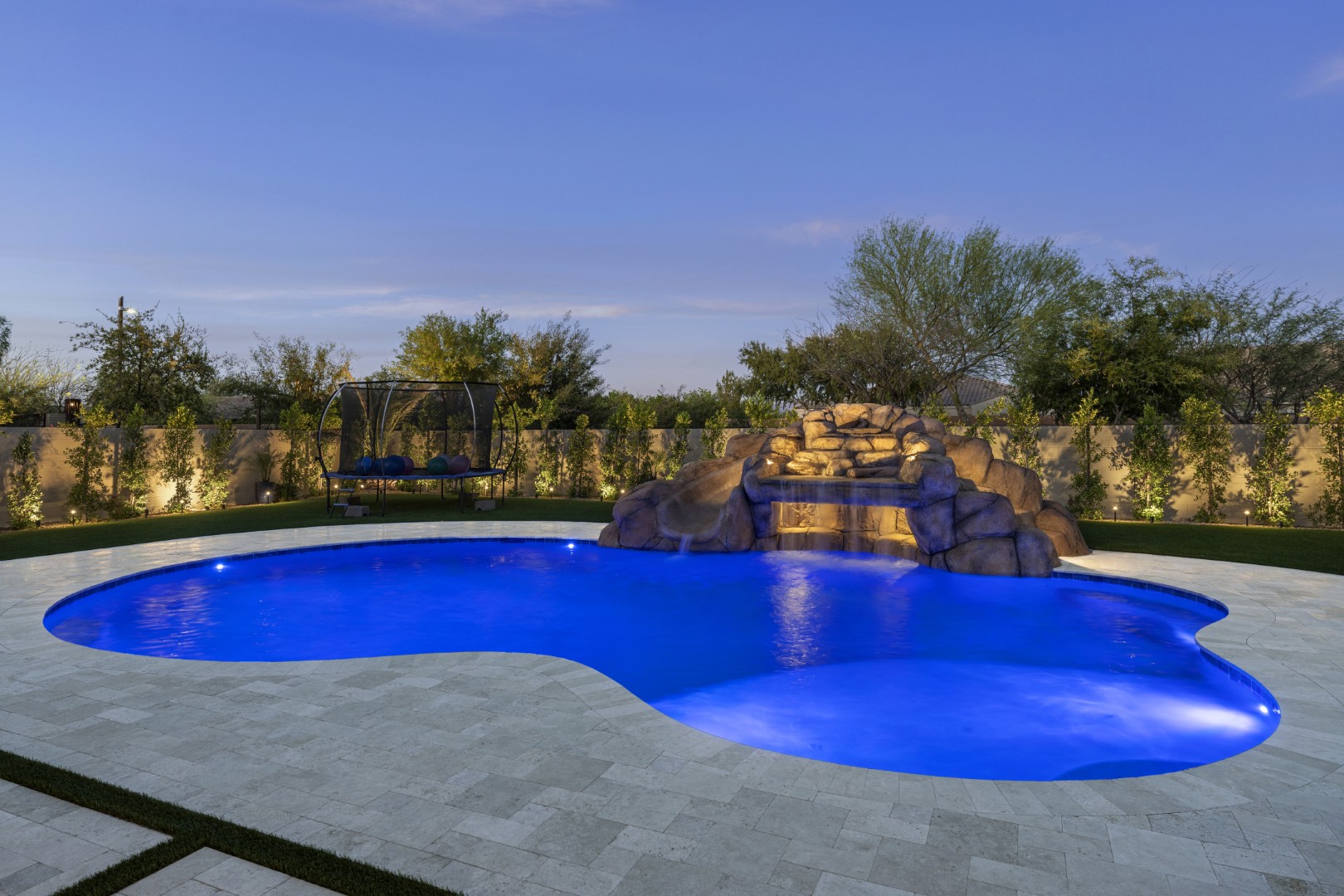 Custom pool with rock waterfall on Quantum Way in Mesa, AZ by Envy Pools
