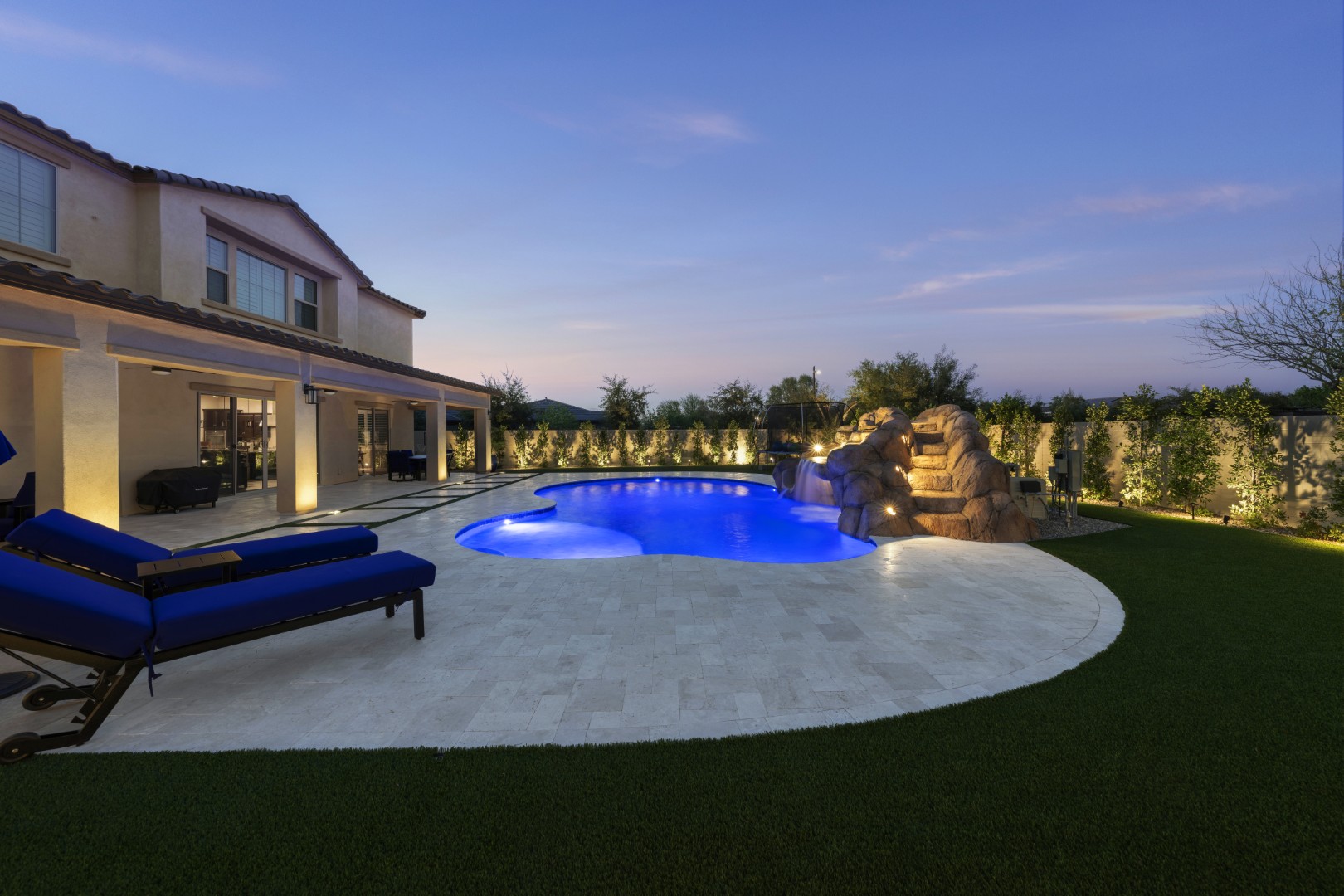 Custom pool with rock waterfall on Quantum Way in Mesa, AZ by Envy Pools
