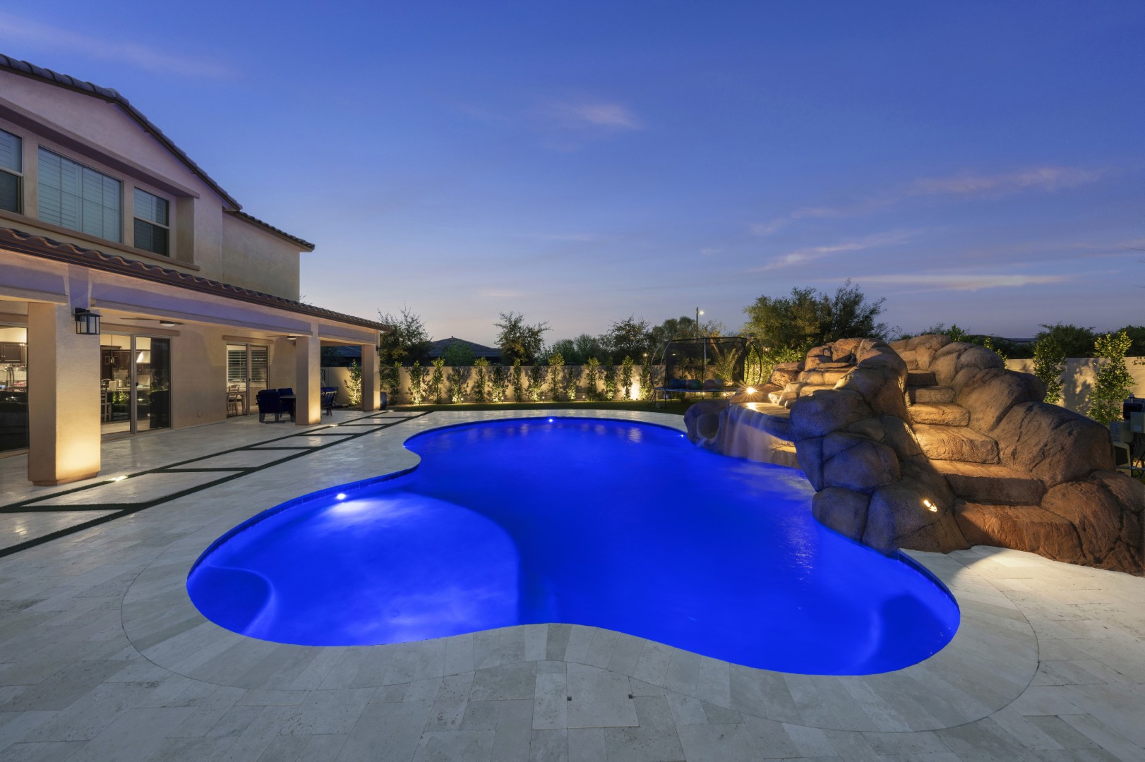 Custom pool with rock waterfall on Quantum Way in Mesa, AZ by Envy Pools