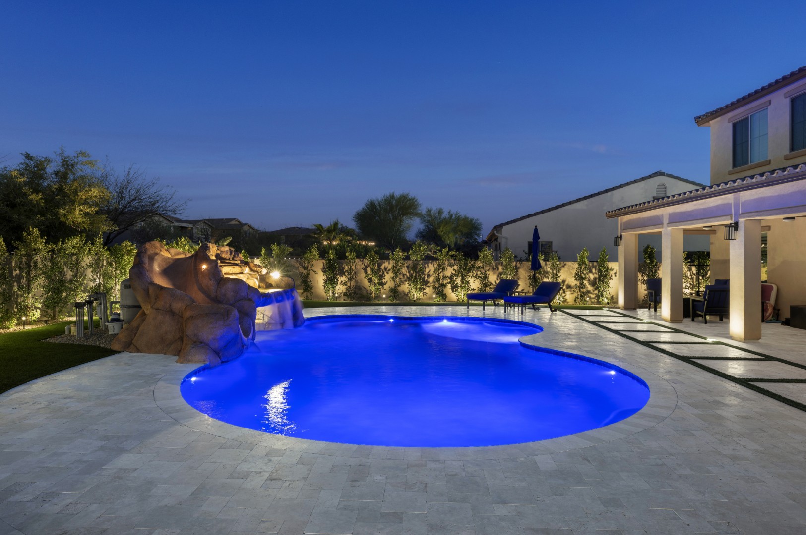 Custom pool with rock waterfall on Quantum Way in Mesa, AZ by Envy Pools