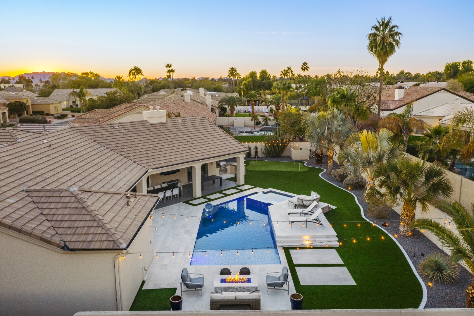 Custom geometric pool with raised spa and putting green in Scottsdale, AZ by Envy Pools