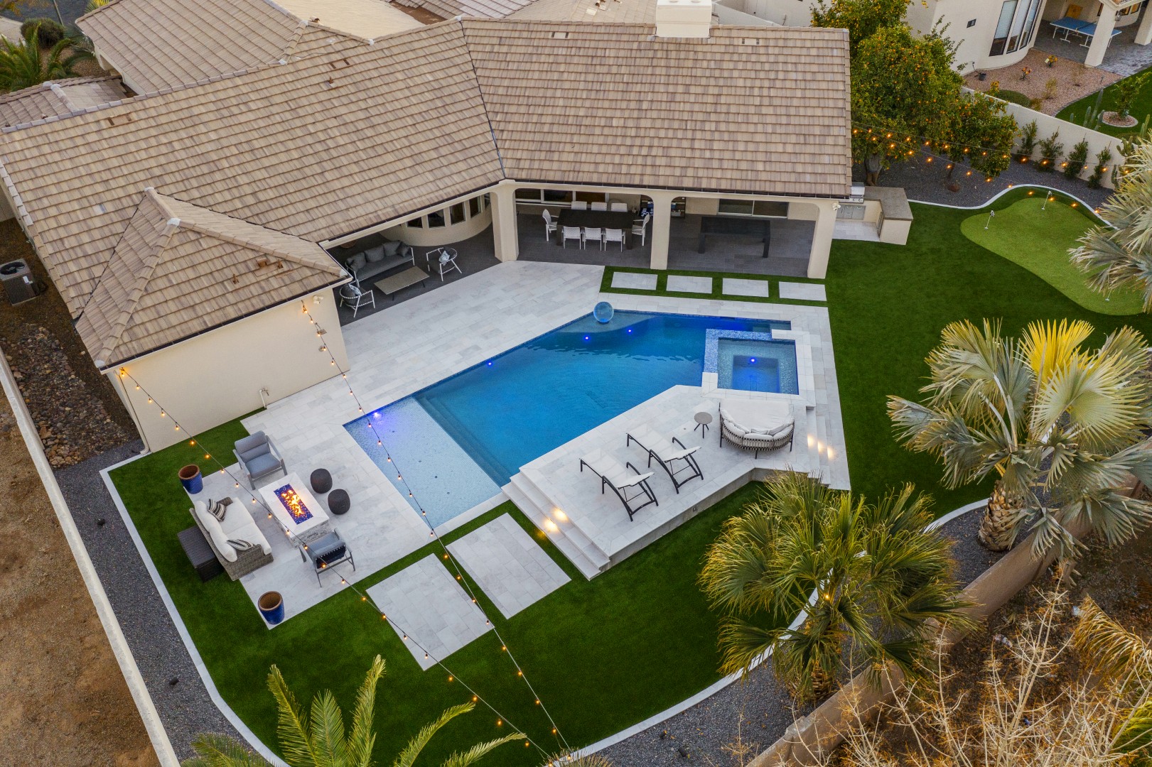 Custom geometric pool with raised spa and putting green in Scottsdale, AZ by Envy Pools