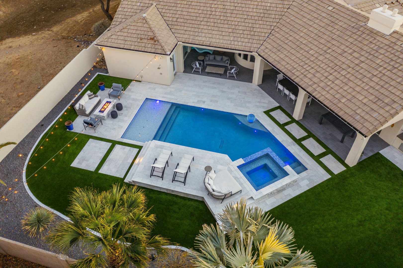 Custom geometric pool with raised spa and putting green in Scottsdale, AZ by Envy Pools