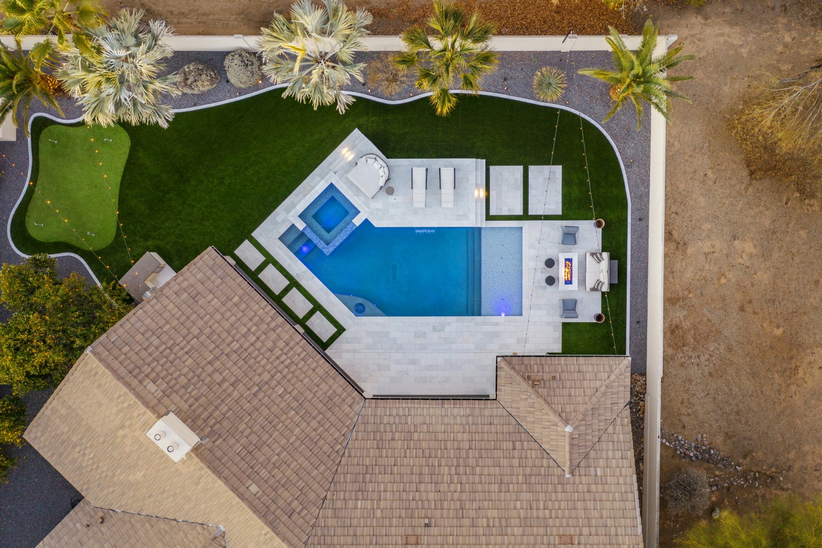 Custom geometric pool with raised spa and putting green in Scottsdale, AZ by Envy Pools