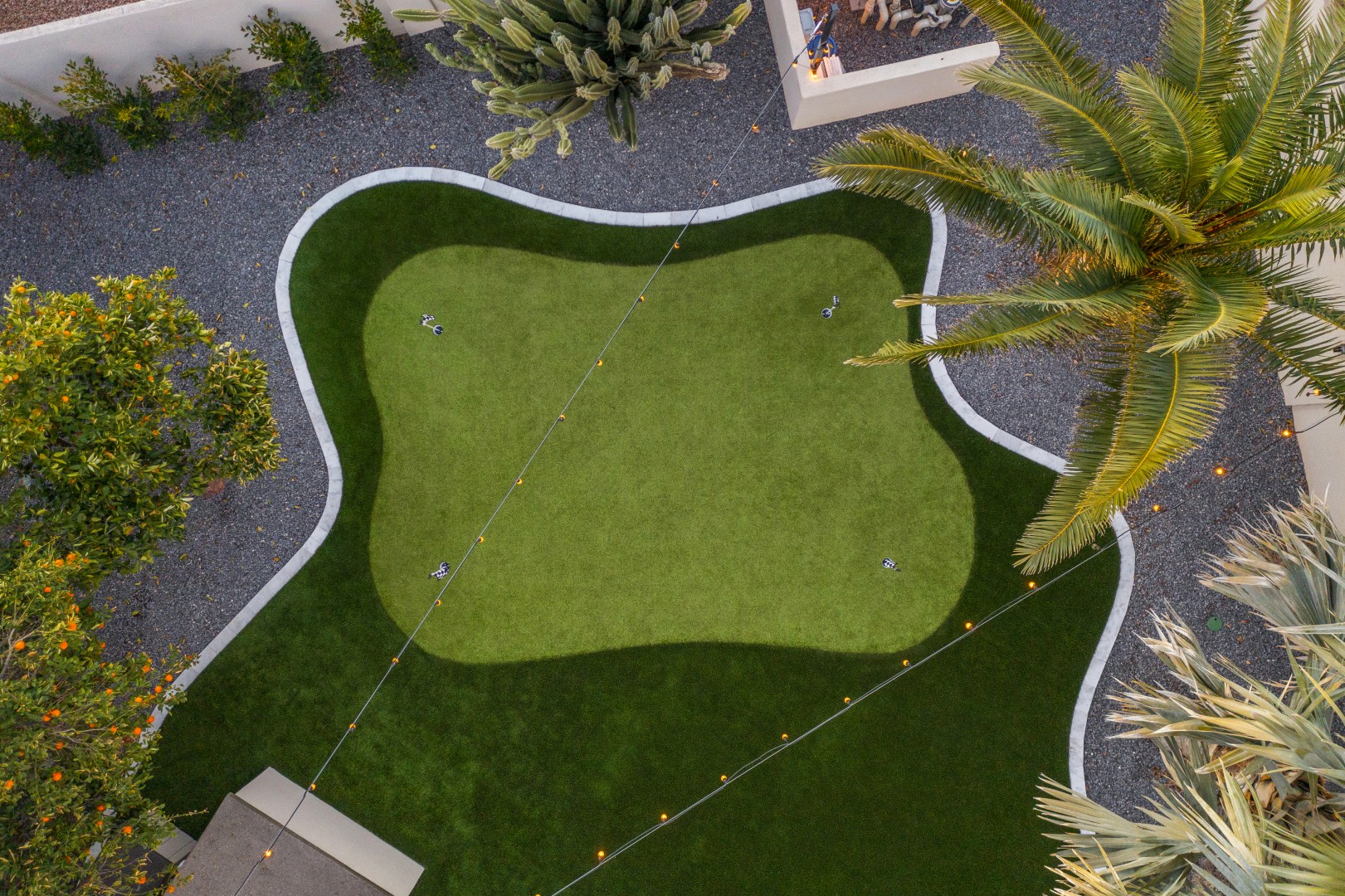 Custom geometric pool with raised spa and putting green in Scottsdale, AZ by Envy Pools