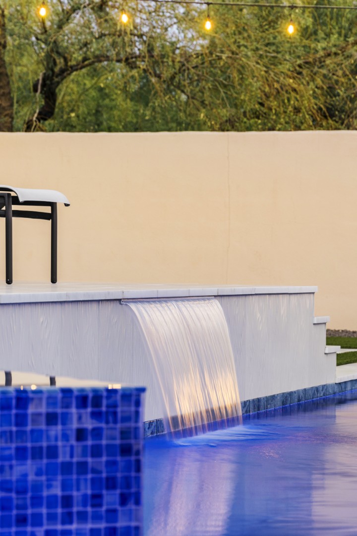 Custom geometric pool with raised spa and putting green in Scottsdale, AZ by Envy Pools