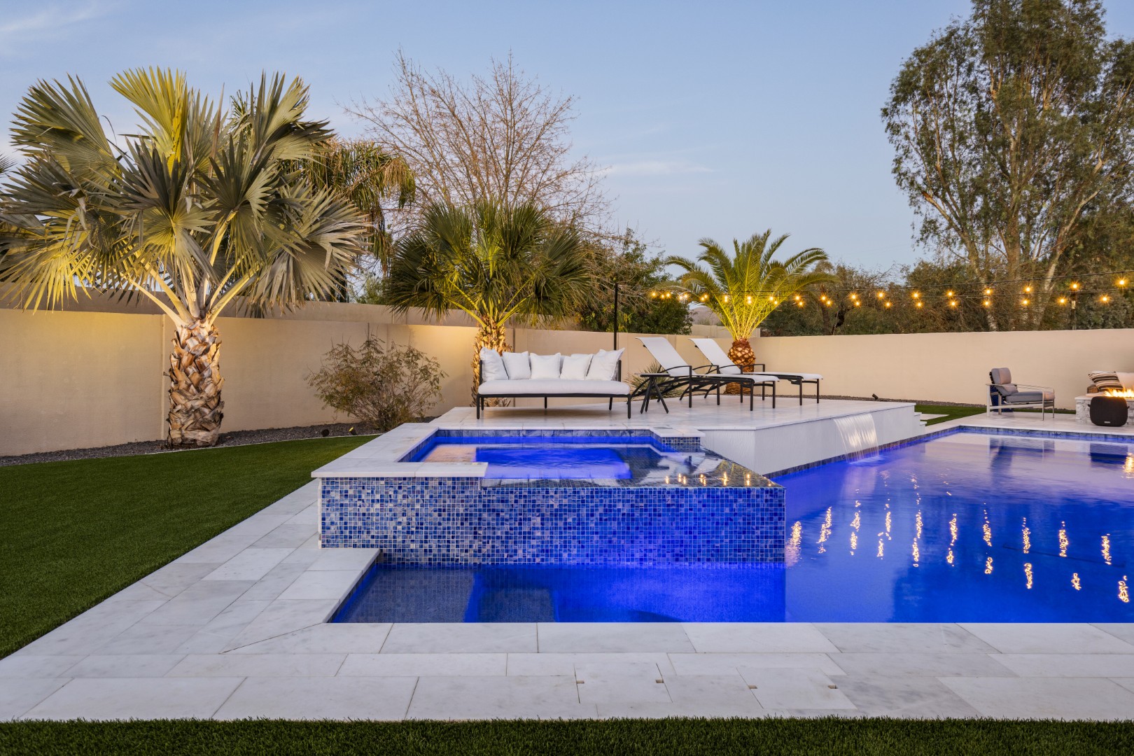 Custom geometric pool with raised spa and putting green in Scottsdale, AZ by Envy Pools