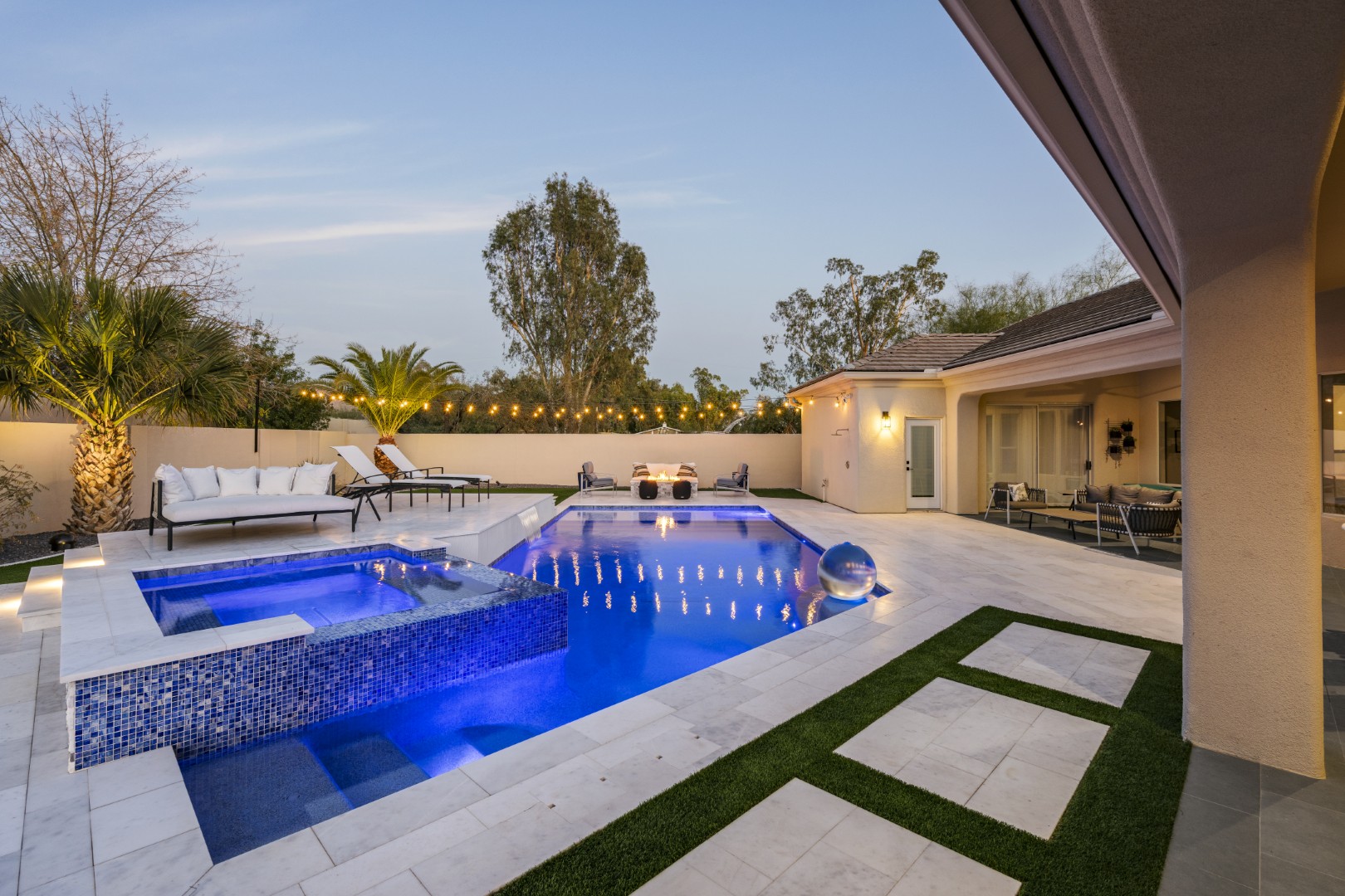 Custom geometric pool with raised spa and putting green in Scottsdale, AZ by Envy Pools