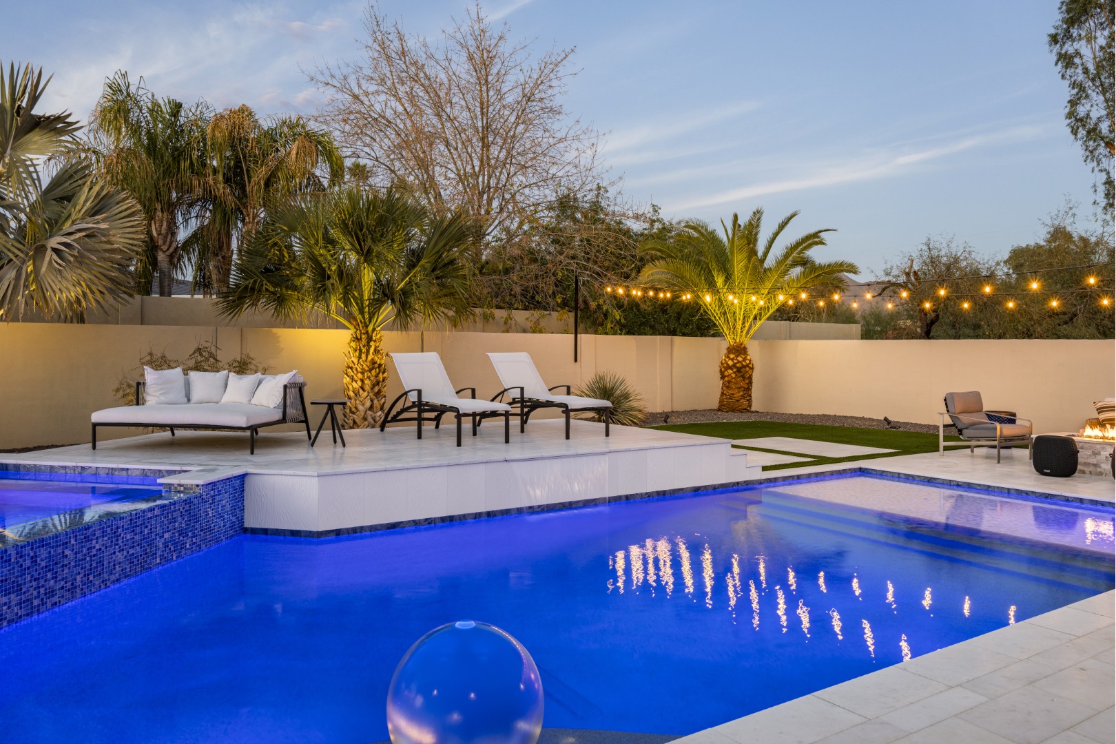 Custom geometric pool with raised spa and putting green in Scottsdale, AZ by Envy Pools