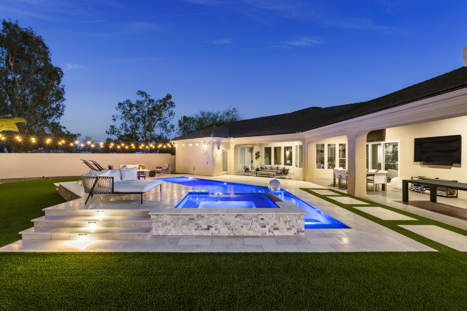 Custom geometric pool with raised spa and putting green in Scottsdale, AZ by Envy Pools