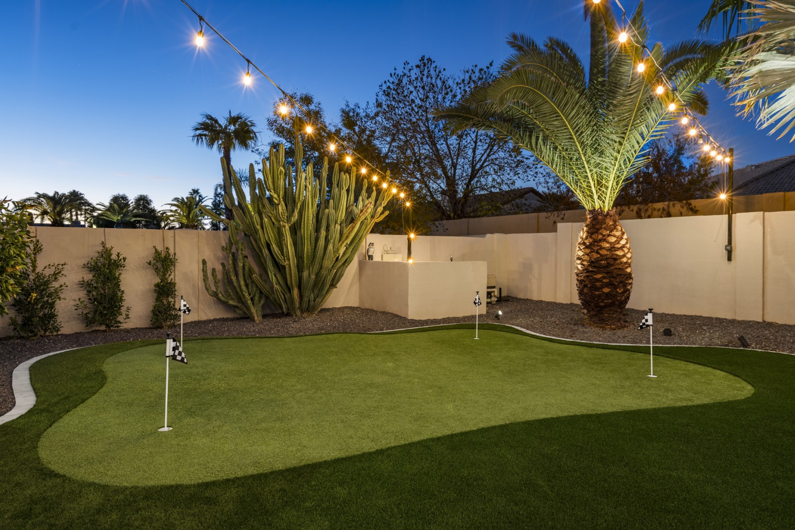 Custom geometric pool with raised spa and putting green in Scottsdale, AZ by Envy Pools