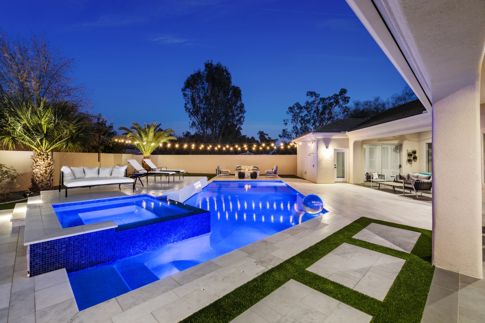 Custom geometric pool with raised spa and putting green in Scottsdale, AZ by Envy Pools
