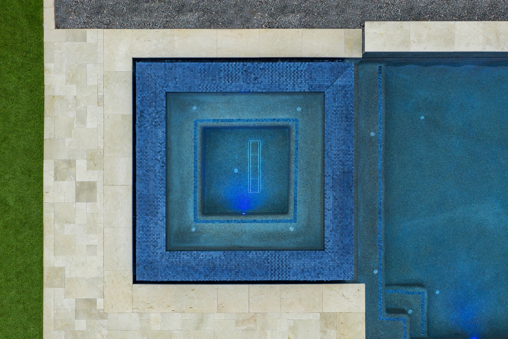 Custom pool with fire and water feature wall, raised spa, and outdoor kitchen in Gilbert, AZ by Envy Pools