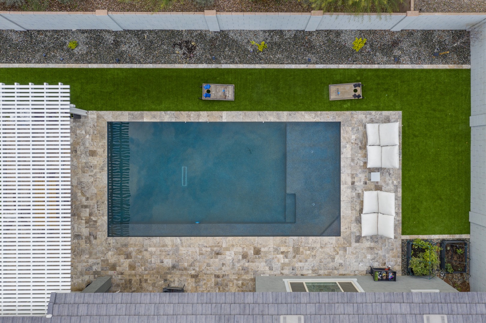Modern rectangular pool with pergola-covered patio in Mesa, AZ by Envy Pools