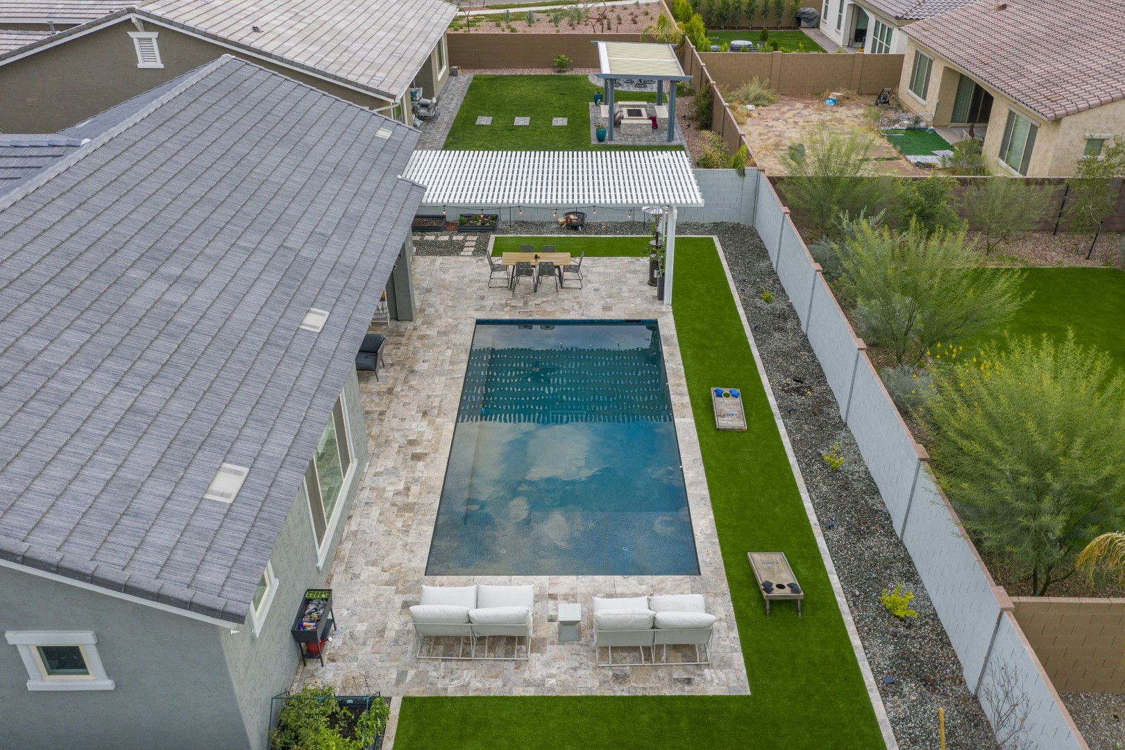 Modern rectangular pool with pergola-covered patio in Mesa, AZ by Envy Pools