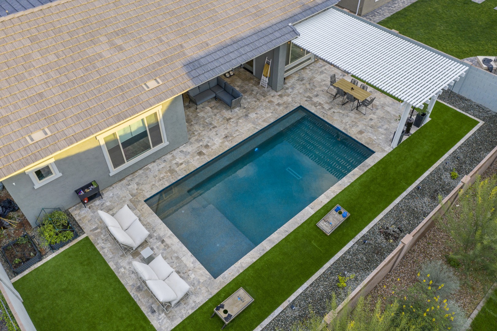 Modern rectangular pool with pergola-covered patio in Mesa, AZ by Envy Pools