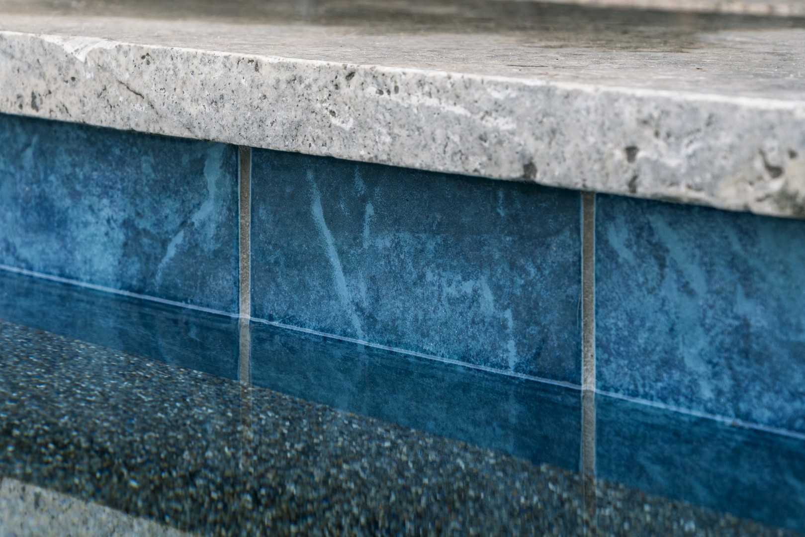 Modern rectangular pool with pergola-covered patio in Mesa, AZ by Envy Pools