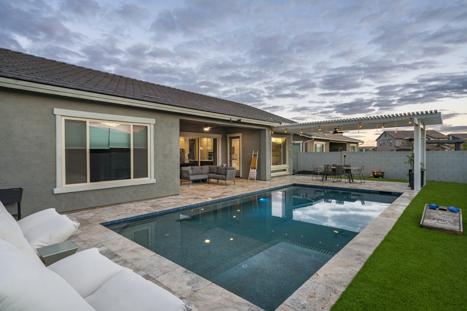 Modern rectangular pool with pergola-covered patio in Mesa, AZ by Envy Pools