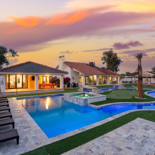 Lazy river and resort style pool lit at dusk in Glendale, AZ