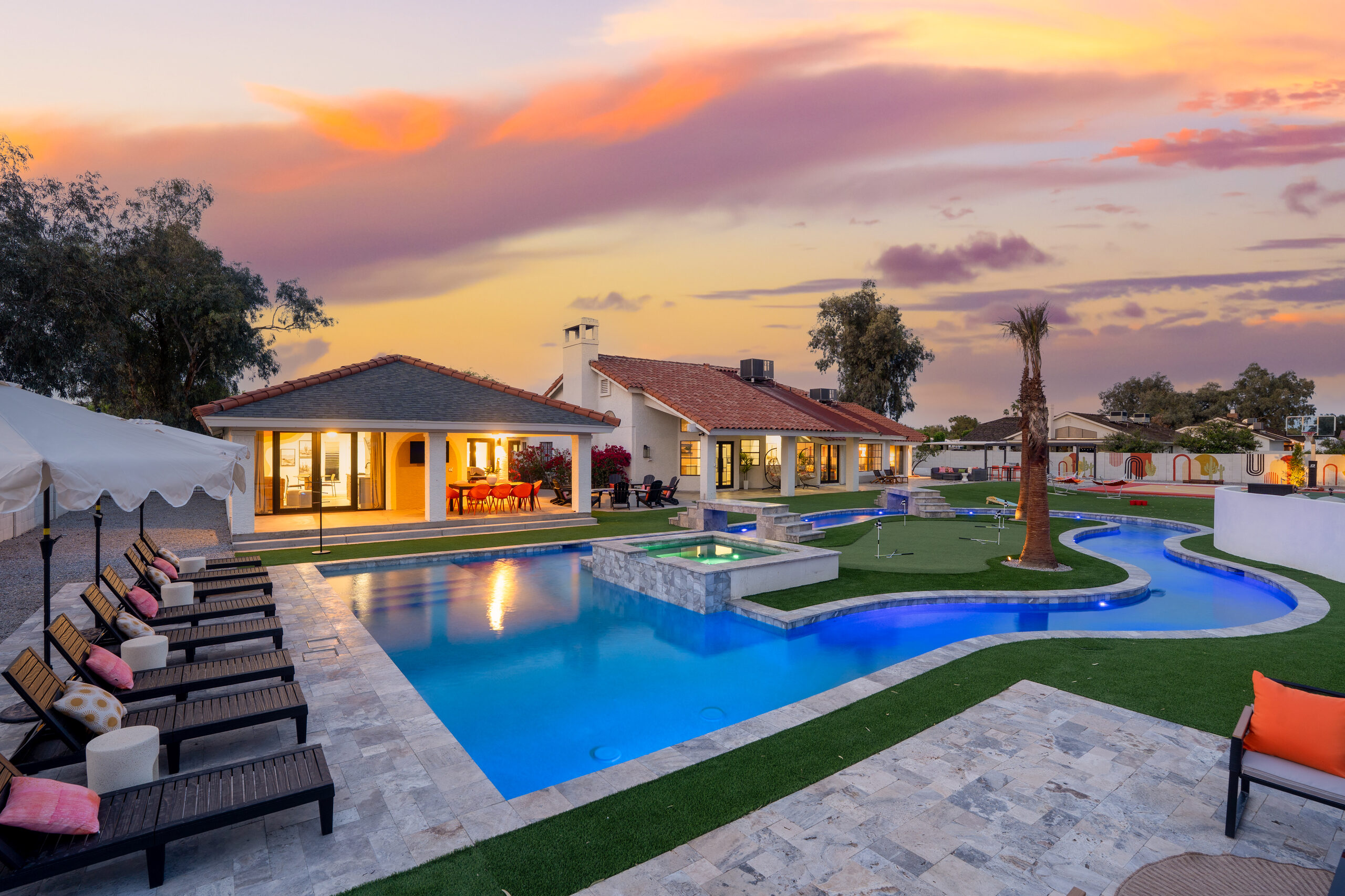Lazy river and resort style pool lit at dusk in Glendale, AZ